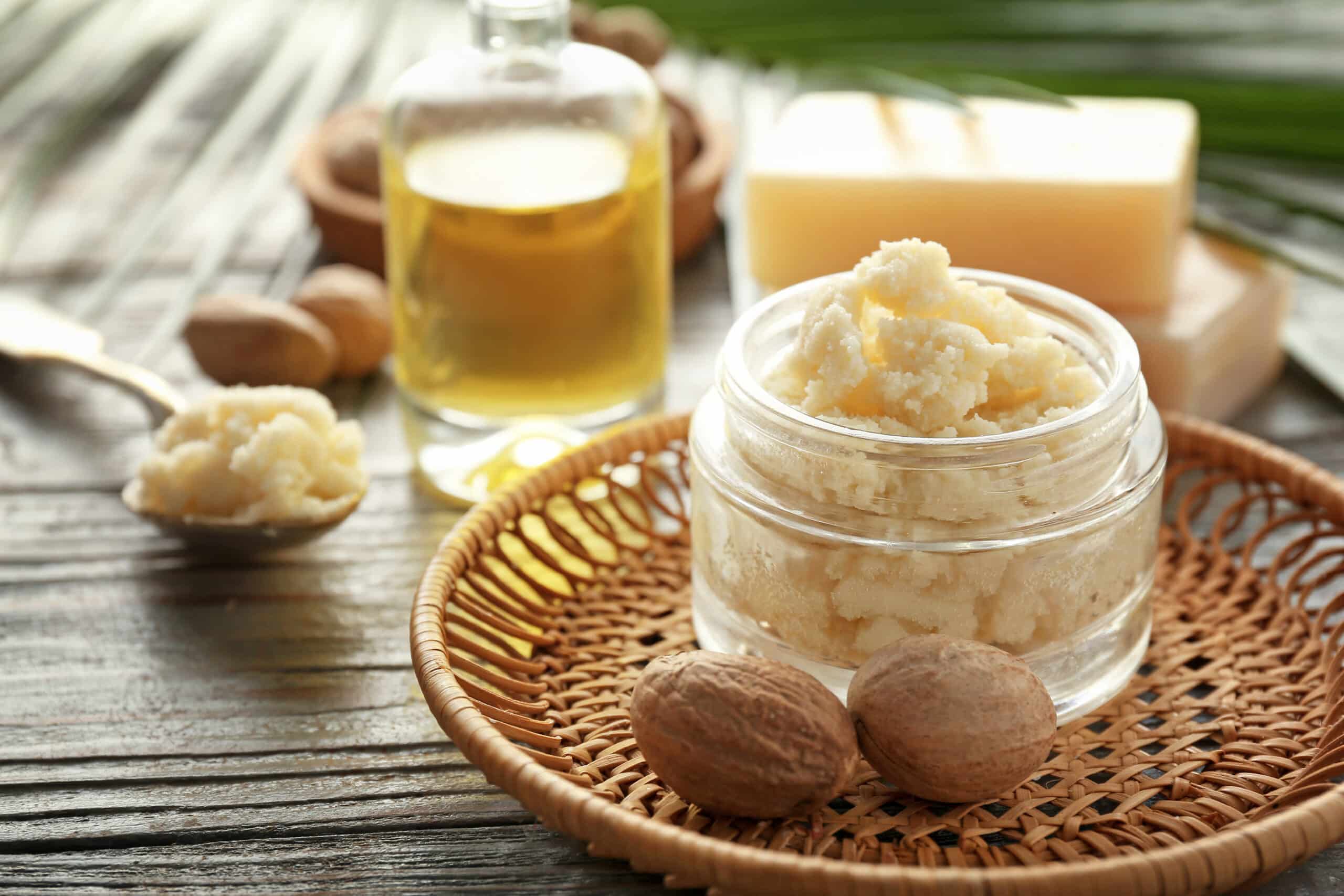 Image of a jar of shea butter with a spoon ready to scoop out shea butter for skin moisturizing.