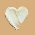 Heart shape shea butter cream texture smudge stroke on beige