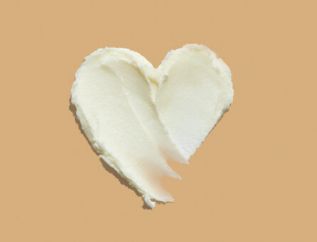 Heart shape shea butter cream texture smudge stroke on beige
